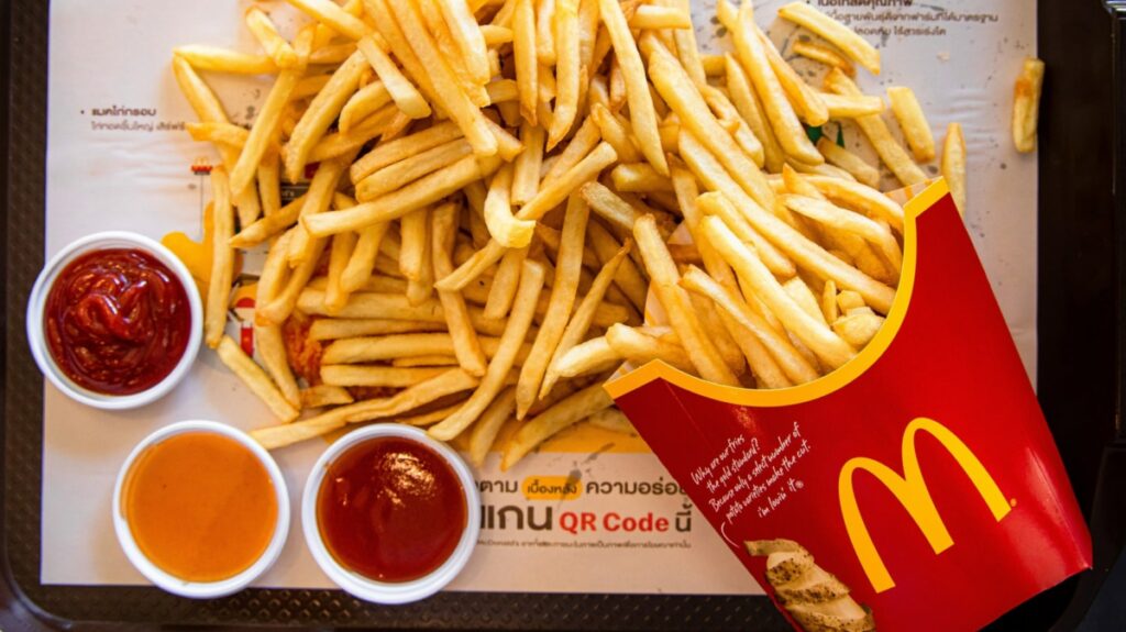 mcd ketchups with fries on table