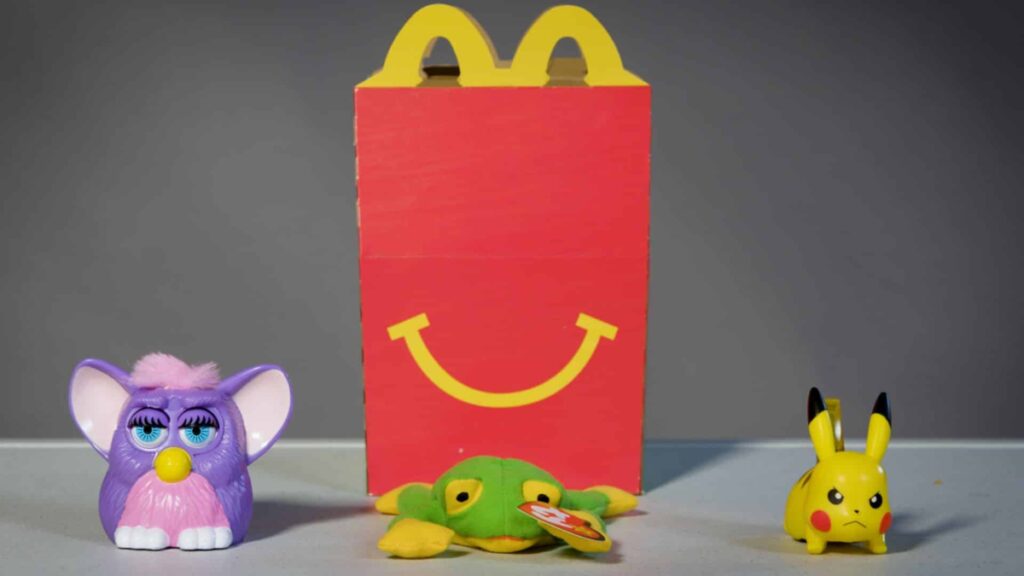 happy meal toys in front of wrap box of MCD
